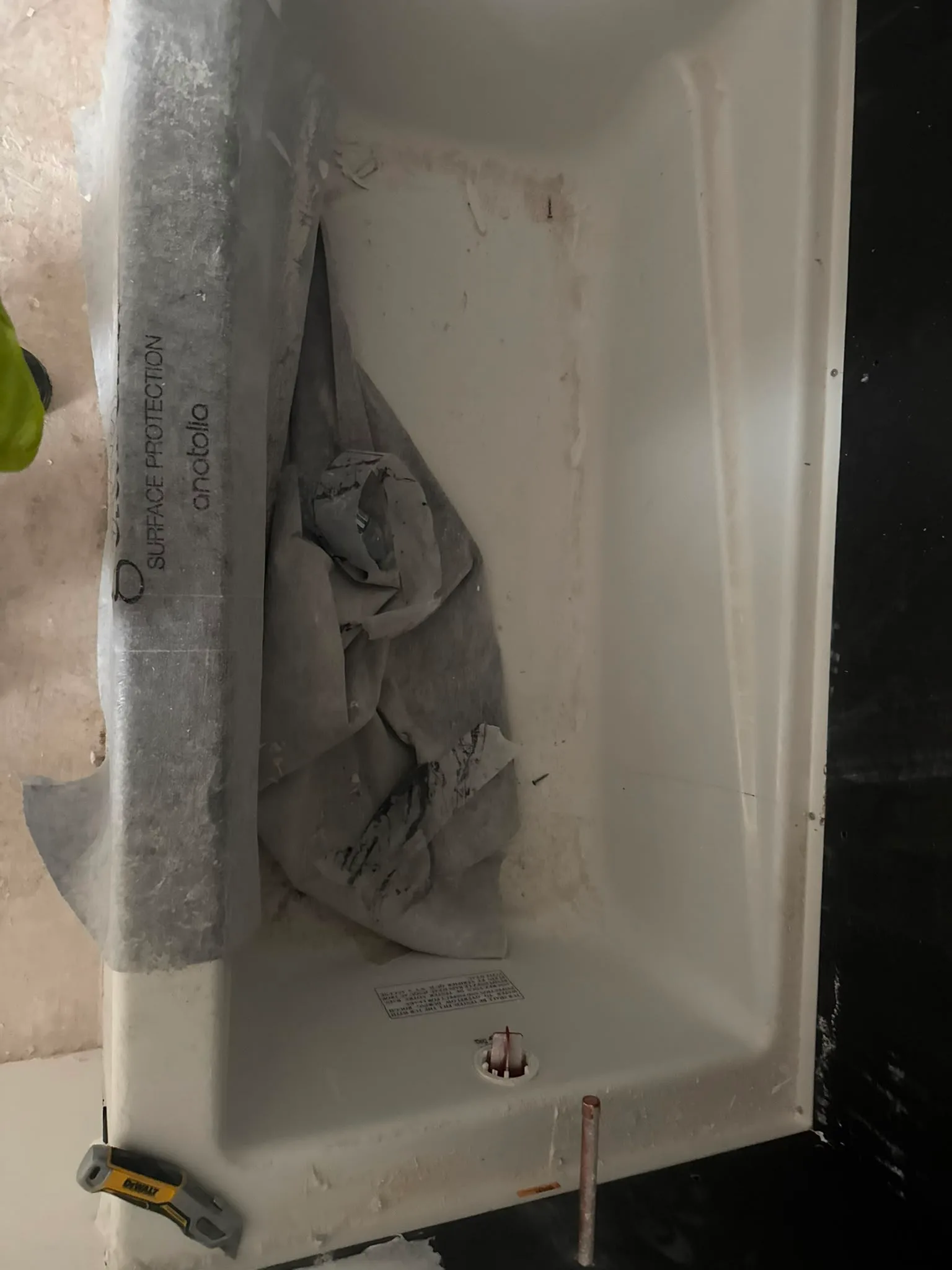 Post-construction bathtub cleaning before and after, before